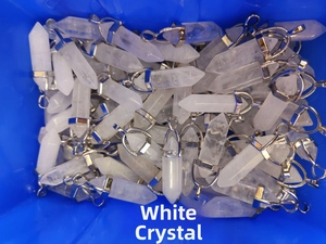 Detailed pile of white crystal hexagonal column pendants with silver metal clasps