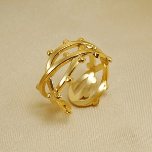 Detail of 18K gold-plated stainless steel ring with layered woven texture and bead accents