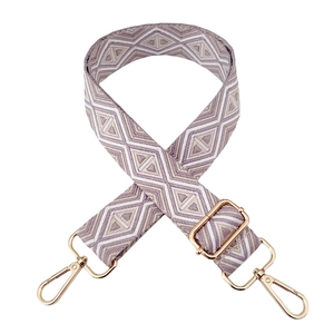 Detail of wide adjustable shoulder strap with purple and beige geometric diamond pattern
