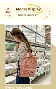 Pink corduroy backpack with bow patterns shown in a lifestyle campus setting