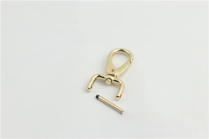 Close-up of gold metal lobster clasp with screw-in bar for handbag strap attachment