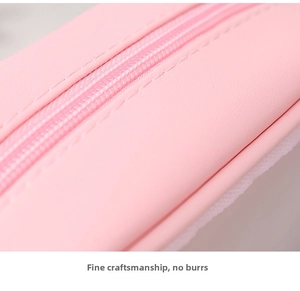 Close-up of smooth nylon zipper and neat stitching on pink waterproof PVC bag