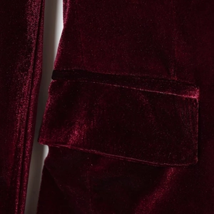Detailed side view of deep red velvet blazer showing premium fabric texture and pocket design
