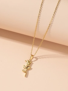 Detailed close-up of a gold 3D rose pendant necklace on elegant beige background