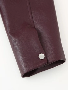 Detailed macro view of dark purple PU leather jacket cuff with a silver snap button