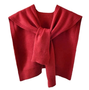 Elegant red knit shawl capelet wrap with a front knot design over a white background