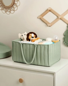 Detailed view of a green quilted baby diaper organizer bag filled with baby essentials
