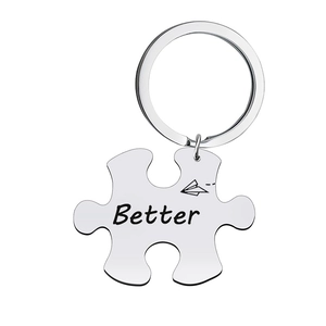 Detailed macro view of a puzzle-shaped stainless steel keychain with Better engraving