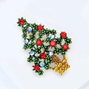 Green enamel Christmas tree brooch with sparkling red and colorful rhinestones in gold tone