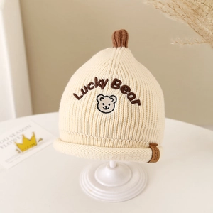 Close-up of baby knit beanie with Lucky Bear embroidery and soft texture details
