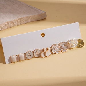 9-piece set of vintage floral resin earrings with pearl accents on display card