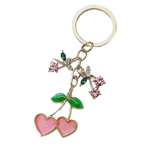 Cute pink heart-shaped cherry keychain with green leaves and gold metal ring