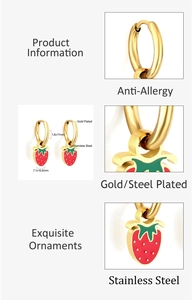 Detail of gold-plated stainless steel hoop earrings with red strawberry pendants