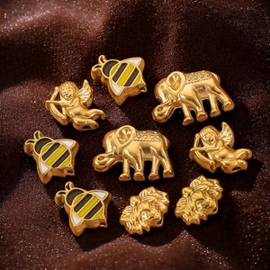 Golden stainless steel animal charms including elephant, bee, and lion for DIY jewelry making