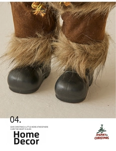 Close-up of Santa doll featuring brown fabric legs, faux fur trim, and matte black boots