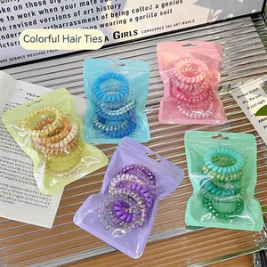 Gradient spiral hair ties in colorful sets organized in translucent zipper bags