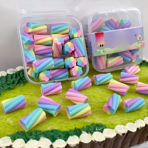 Macro view of macaron rainbow marshmallow-shaped erasers in transparent packaging