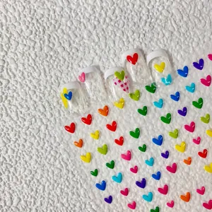 Macro view of 3D colorful heart nail stickers with vibrant embossed relief details