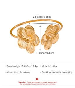 Detail view of gold flower bangle with dimensions and 12.9g weight specifications