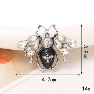 Macro detail of bee-shaped alloy accessory with rhinestones, 4.7cm x 3.8cm size