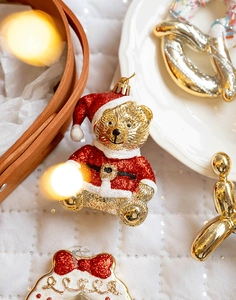 Macro detail of Christmas bear ornament in red sequins and gold metallic finish