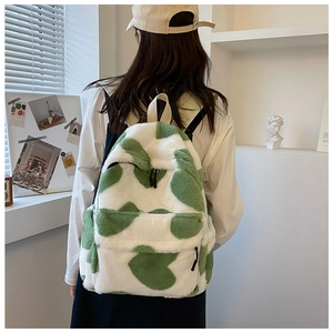 Detail of soft heart-patterned plush backpack with zipper pocket and adjustable straps