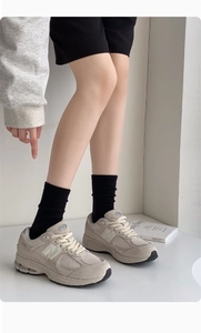 Detail of premium combed cotton black crew socks styled with grey retro sneakers