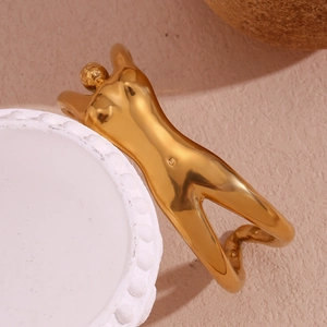 Detailed view of an 18K gold-plated stainless steel bangle in creative female body shape