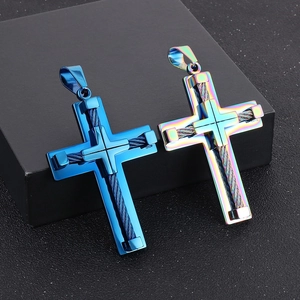 Detail of blue and rainbow steel wire cross pendants on a black gift box