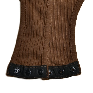 Detail shot of the brown ribbed knit bodysuit bottom featuring secure metal snap buttons