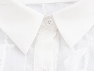 Detail of elegant white blouse collar with refined button and textured fabric texture