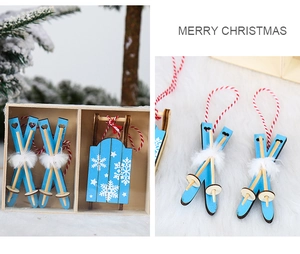 Close-up of wooden blue Christmas sled and ski ornaments with white snowflake patterns