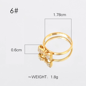 Elegant gold bow ring with pearls and pavé stones in a minimalist stainless steel setting