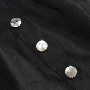 Detail of black twill fabric featuring three silver metallic round buttons on the garment