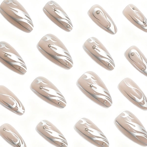 Nude pink almond fake nails with silver flame patterns and metallic rivet accents