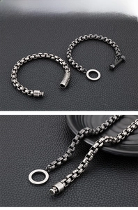 Detailed macro view of vintage square box chain bracelet with magnetic clasp on black leather