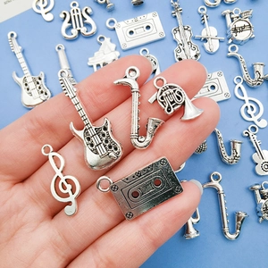Vintage silver music charms featuring guitar, saxophone and music notes for DIY jewelry