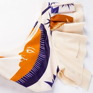 Close-up of ruffled trim and ethnic solar print on cream white bikini swimwear