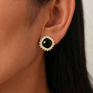Detail of vintage gold sunburst stud earring with black square stone and clear rhinestones