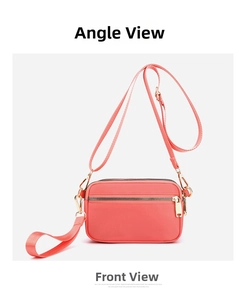 Detailed front view of pink multi-compartment crossbody bag with gold zippers