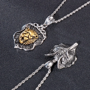 Detail of silver wolf head and gold lion shield pendants on twisted rope necklaces