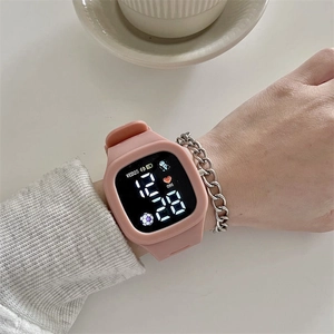 Pink smartwatch with silicone strap worn by model, showing digital screen details