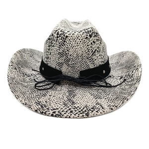 Detailed close-up of wide brim cowboy hat featuring black and white snakeskin print patterns