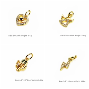 Detail view of gold-plated charms with cubic zirconia including heart and angel shapes