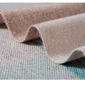 Macro view of the soft cashmere-like weave with teal and beige plaid texture