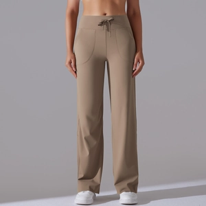 Detail view of khaki high-waisted wide-leg yoga pants with drawstring and pockets