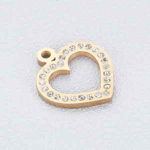 Macro shot of gold hollow heart pendant with sparkling cubic zirconia for DIY jewelry