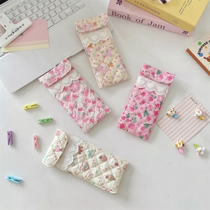 Quilted floral eyewear and stationery pouches with lace trim and heart button detail