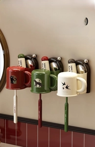 Detail of magnetic wall-mounted cups and toothbrushes for bathroom drainage storage
