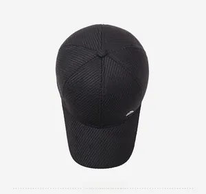 Top down view of black winter baseball cap showing textured fabric and metallic brand tag